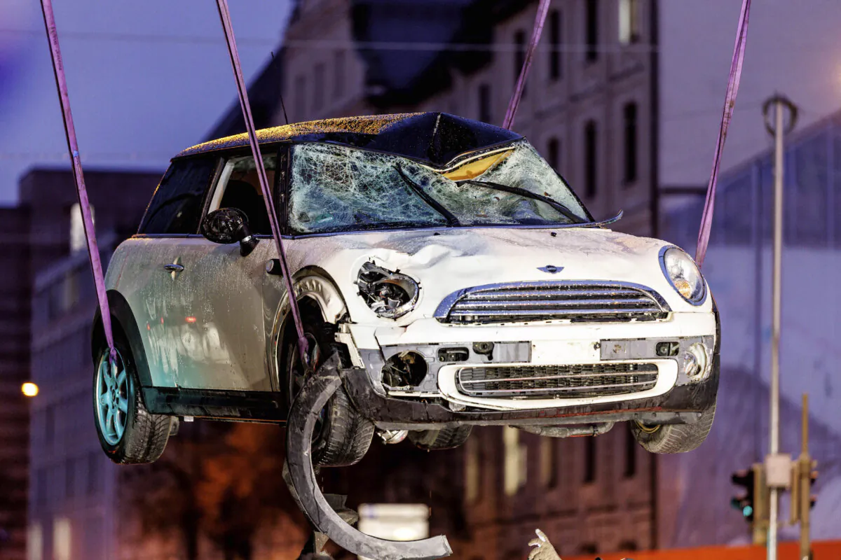 A car is lifted onto a tow truck at the scene where a car was driven into a labor union demonstration in Munich on Feb. 13, 2025. (Matthias Balk/dpa via AP)