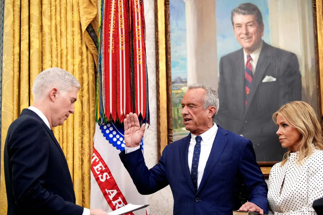 Robert F. Kennedy Jr. joined by his wife Cheryl Hines and his family is sworn in as Secretary of Health and Human Services by Associate Supreme Court Justice Neil Gorsuch in the Oval Office at the White House on Feb. 13, 2025, in Washington. (Andrew Harnik/Getty Images)