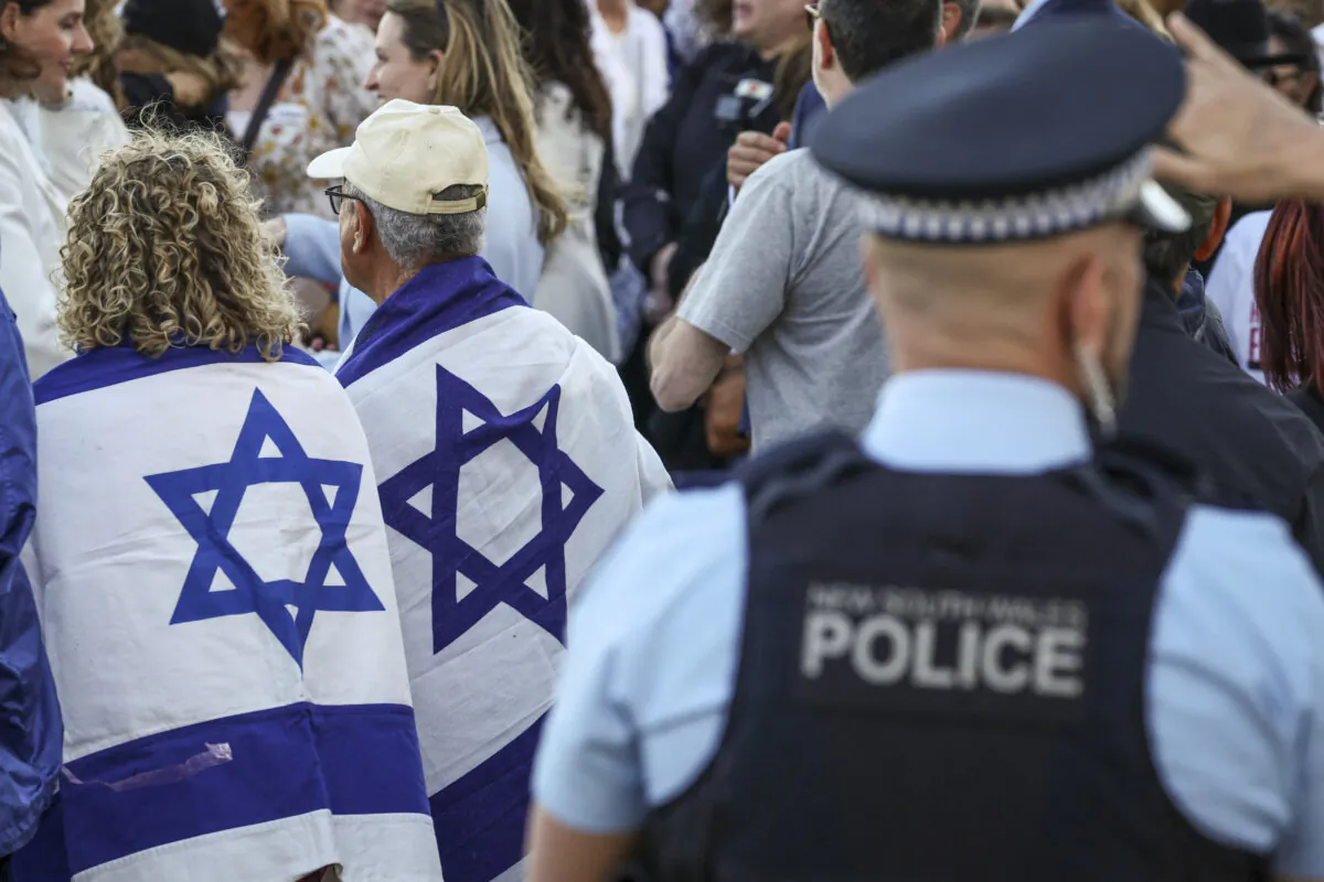 New South Wales police officers stand near members of the Australian Jewish community at a memorial service at Sydney's Bondi Beach in Australia on Sept. 2, 2024. (David Gray/AFP via Getty Images)