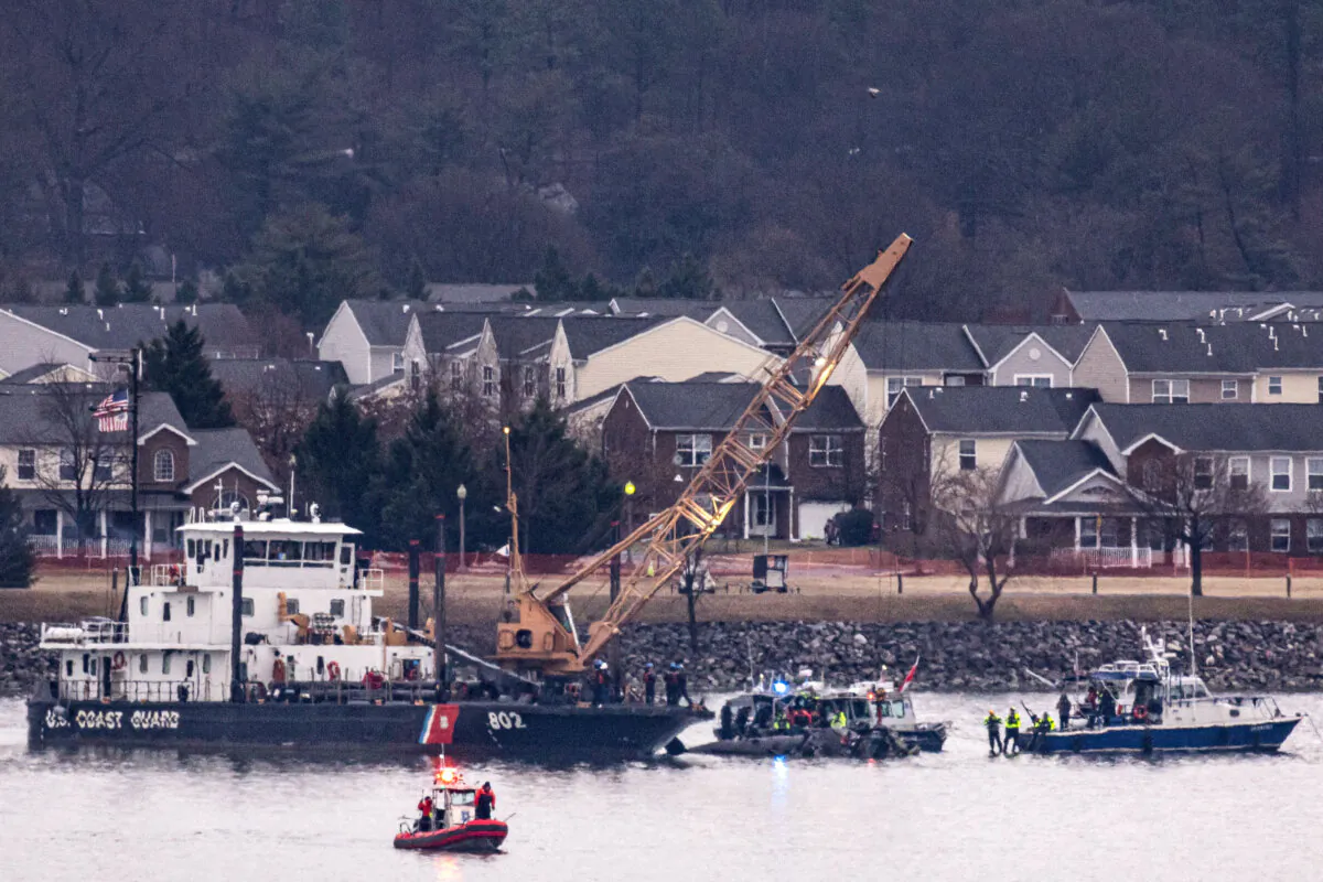 A Coast Guard crane arrives to remove the wreckage of a military Black Hawk helicopter after the crash of an American Airlines plane on the Potomac River as it approached the airport in Arlington, Va., on Jan. 31, 2025. (Al Drago/Getty Images)