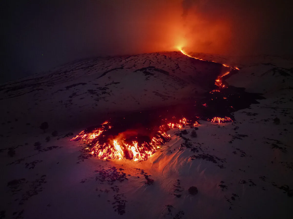 Lava flows from a fracture on the Mount Etna during an eruption of the volcano in Sicily, on Feb. 14, 2025. (Etna Walk/AFP via Getty Images)