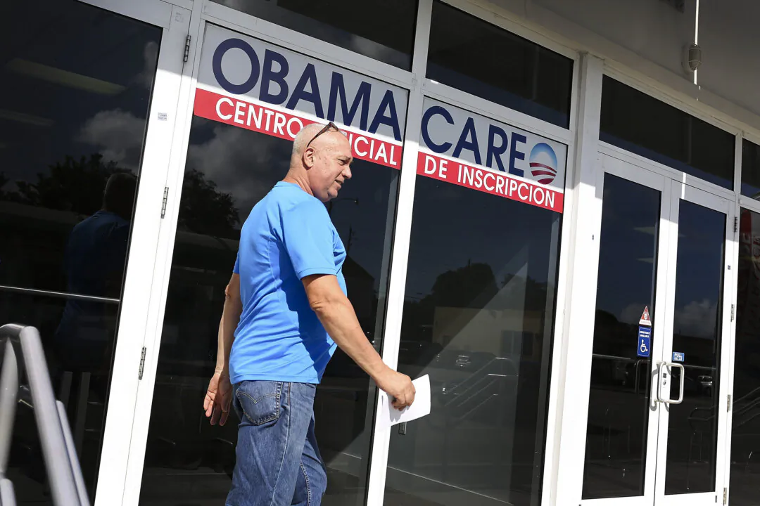 A man leaves a Univista Insurance office after shopping for a health plan under the Affordable Care Act, also known as Obamacare, in Miami in December 2015. (Joe Raedle/Getty Images)