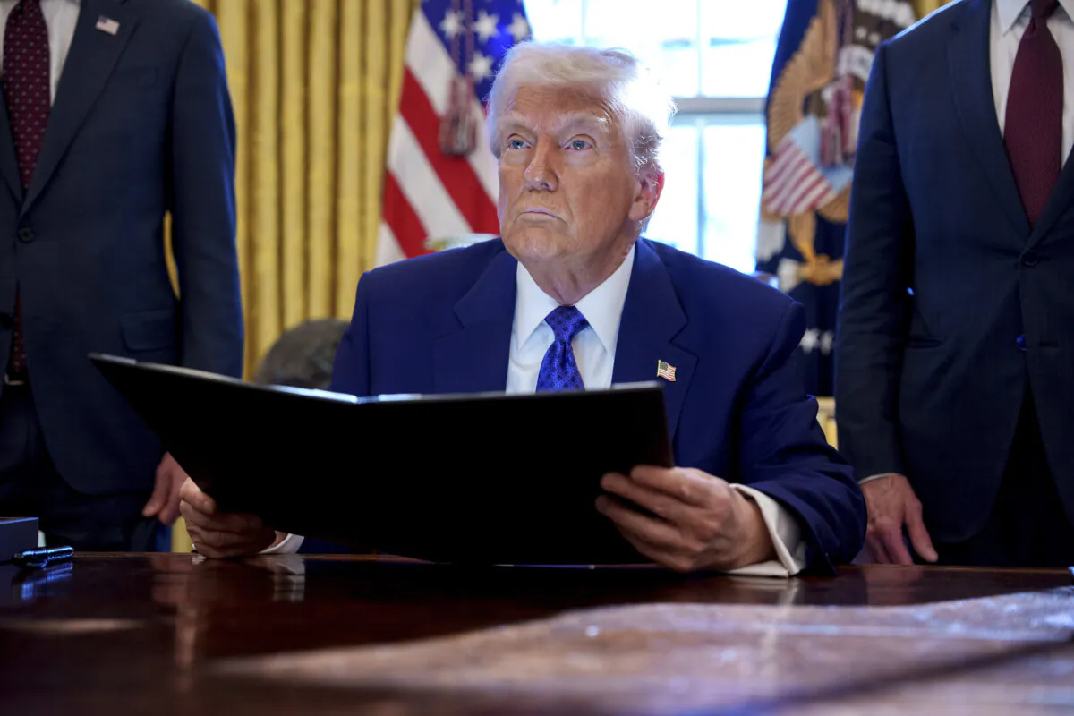 President Donald Trump holds an executive order establishing the Energy Dominance Council led by Secretary of the Interior Doug Burgum in the Oval Office at the White House on Feb. 14, 2025. (Andrew Harnik/Getty Images)