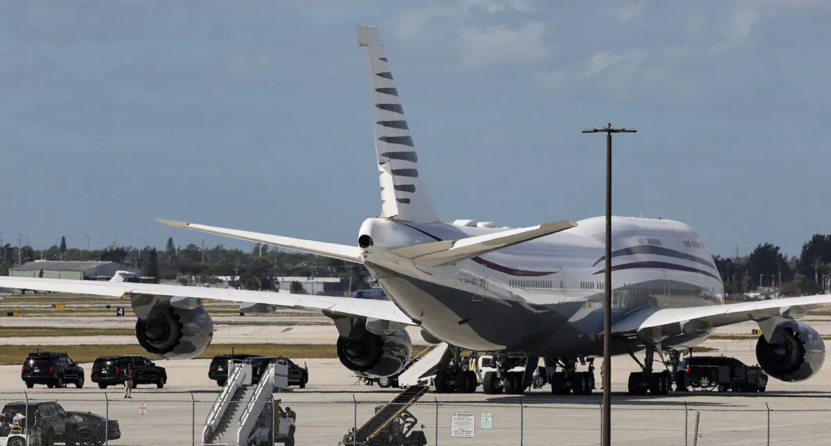The motorcade of President Donald Trump is parked next to a 12-year old Boeing 747-8 that Trump was touring in West Palm Beach, Fla., on Feb. 15, 2025. (Kevin Lamarque/Reuters)