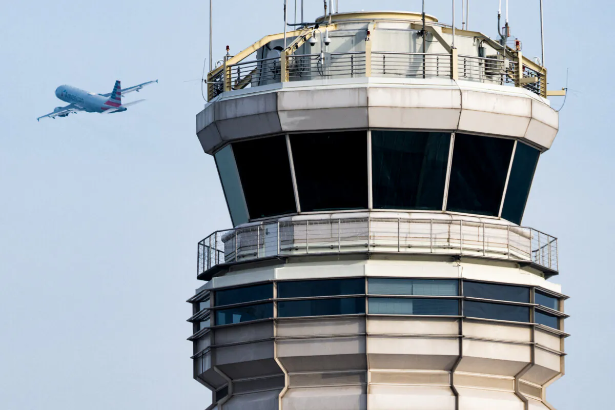 An American Airlines Airbus A319 takes off past the air traffic control tower at Ronald Reagan Washington National Airport in Arlington, Va., on Jan. 11, 2023. (Saul Loeb/AFP via Getty Images)
