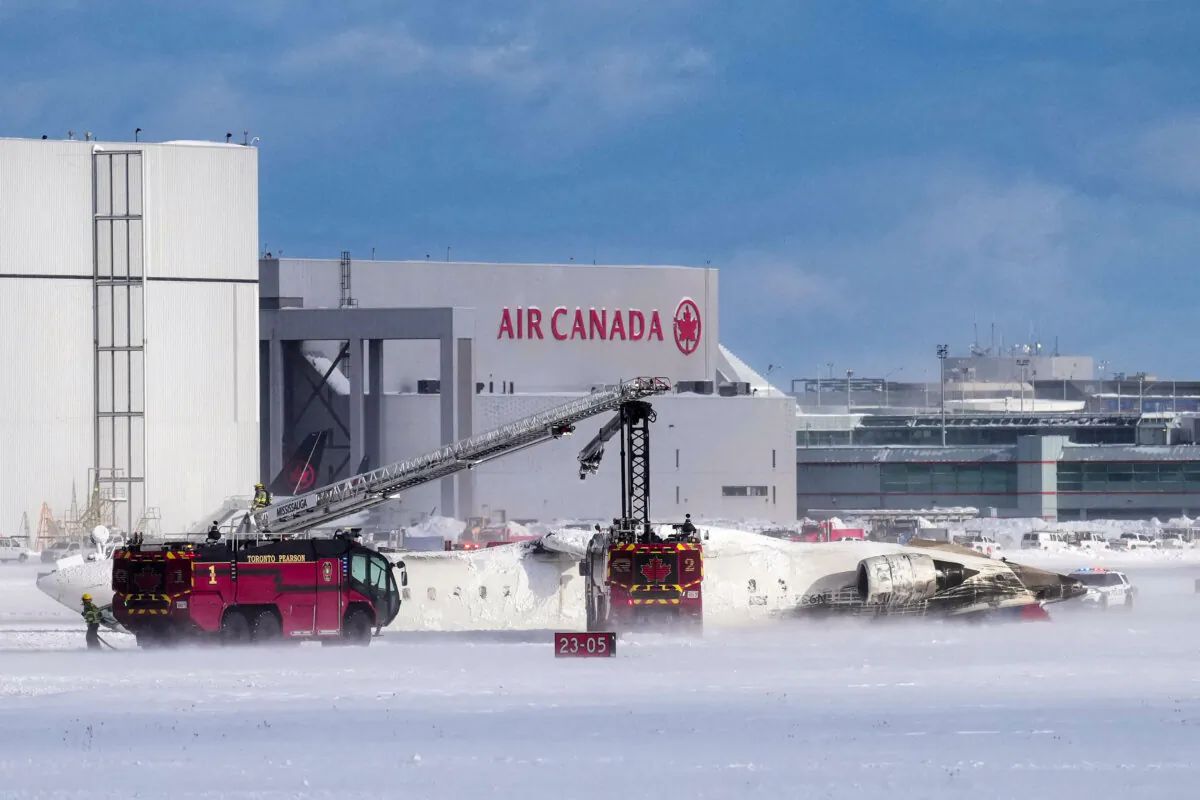 First responders work at the Delta Air Lines plane crash site at Toronto Pearson International Airport in Mississauga, Canada, on Feb. 17, 2025. (Arlyn McAdorey/Reuters)