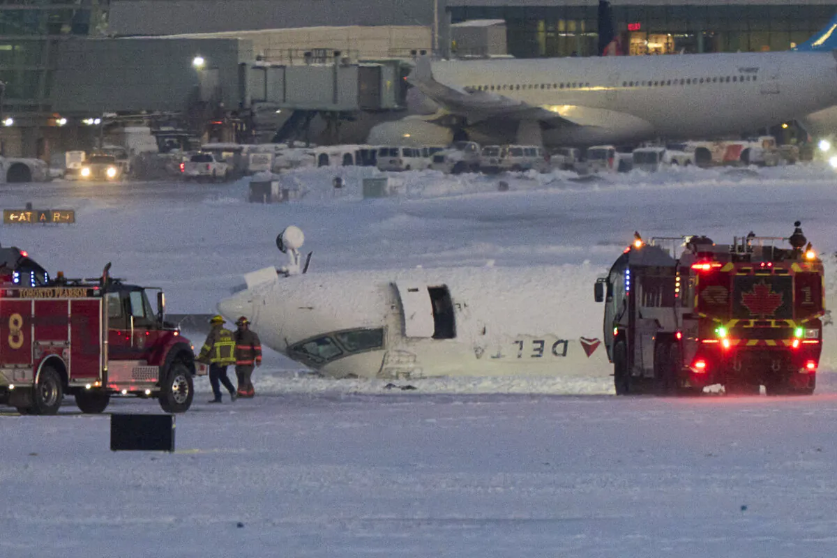 A Delta airlines plane sits on its roof after crashing upon landing at Toronto Pearson Airport in Toronto, Ontario, on Feb. 17, 2025. (Geoff Robins/AFP via Getty Images)