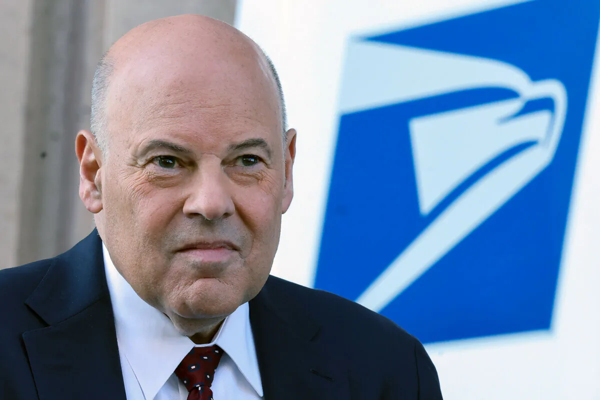 Louis DeJoy, the U.S. Postmaster General, attends an event announcing the Postal Service's plan on implementing electric vehicles, at the Postal Service Headquarters in Washington on Dec. 20, 2022. (Kevin Dietsch/Getty Images)