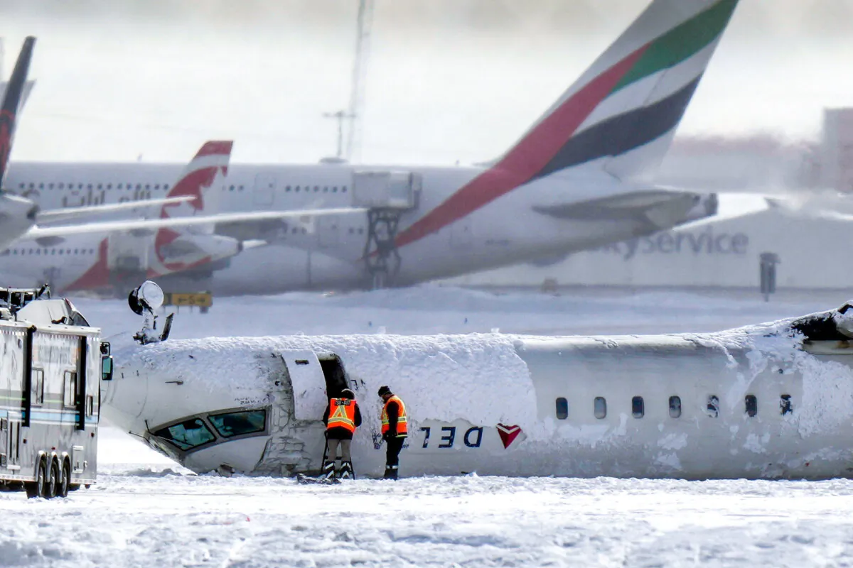 A Delta Air Lines plane lies upside down at Toronto Pearson Airport on Feb. 18, 2025. All 80 aboard the Delta jet survived after it burst into flames on a Toronto runway. (Chris Young/The Canadian Press via AP)