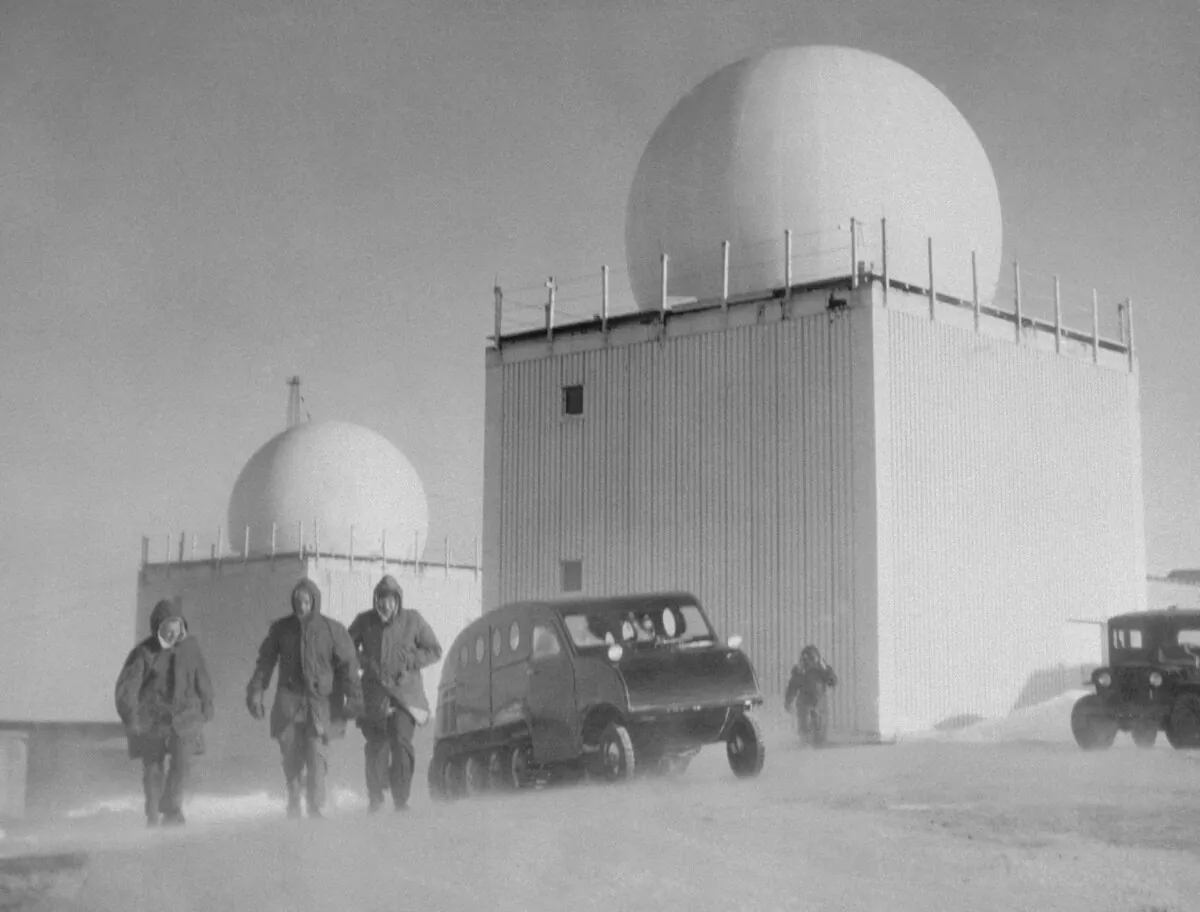 Radar domes seen above the roofs of buildings at a radar site, on Baffin Island, now in Nunavut, on April 10, 1956. Members of the radar force are seen struggling through the wind-blown snow. This site, above the Arctic Circle, is one of a number being built along a 3,000 mile distant early warning line from Baffin Island to Alaska. (AP Photo)