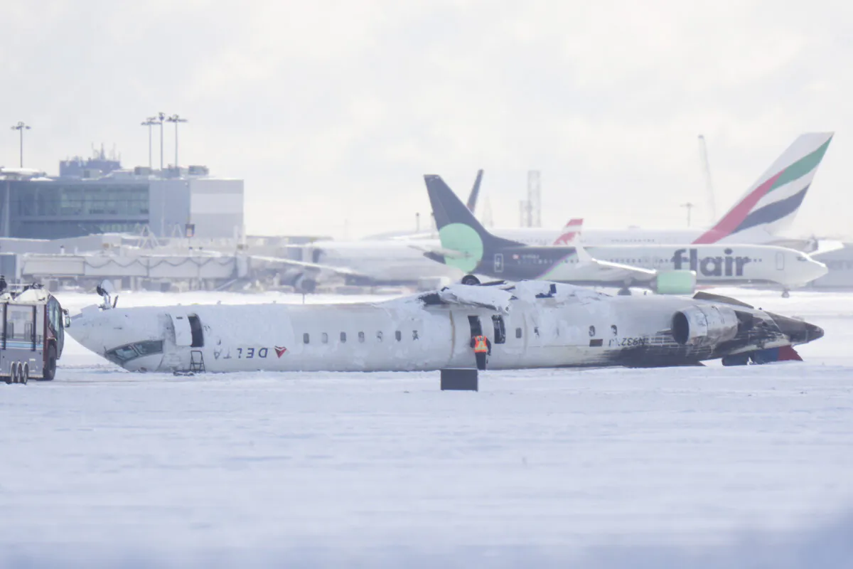 A Delta Air Lines plane lies upside down at Toronto Pearson Airport on Feb. 18, 2025. (The Canadian Press/Chris Young)