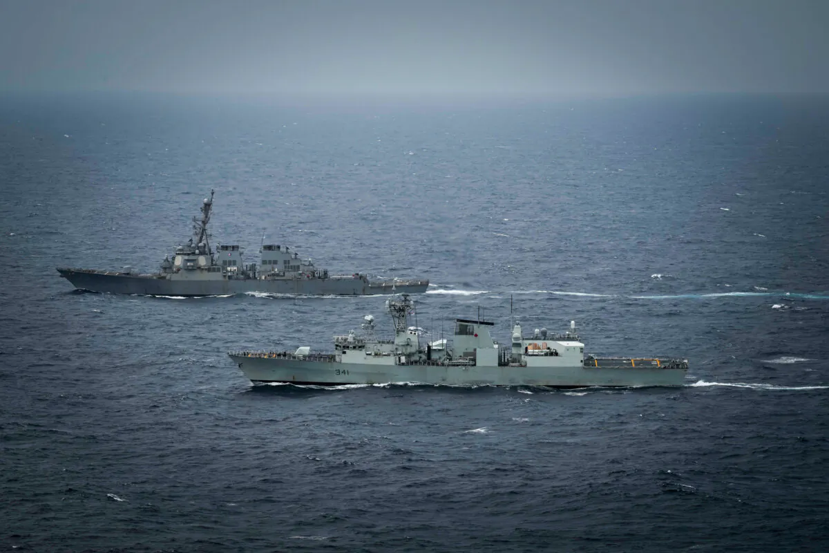 The guided-missile destroyer USS Higgins (DDG 76) and the Royal Canadian Navy HMCS Ottawa (FFH 341) maneuver in international waters during exercise Noble Wolverine in the South China Sea on Jan. 11, 2025. (U.S. Navy photo courtesy of Royal Canadian Navy by Sailor 3rd Class Jacob Saunders)