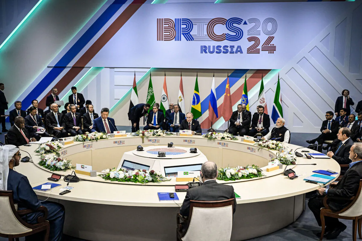 United Arab Emirates President Sheikh Mohamed bin Zayed Al Nahyan, South African President Cyril Ramaphosa, Chinese leader Xi Jinping, Russian President Vladimir Putin, Indian Prime Minister Narendra Modi, Egyptian President Abdel Fattah al-Sisi, Iranian President Masoud Pezeshkian, and Brazilian Foreign Minister Mauro Vieira attend a meeting of the BRICS summit in Kazan, Russia, on Oct. 23, 2024. (Alexander Nemenov/Pool/AFP via Getty Images)