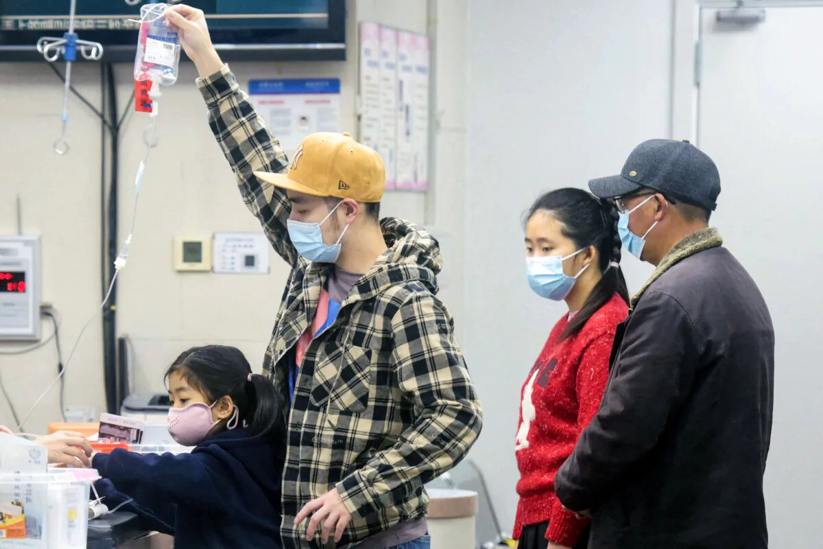 A family member holds an IV drip for a child receiving care at the pediatric department of a hospital in Hangzhou, eastern Zhejiang Province, China, on Jan. 6, 2025. (AFP via Getty Images)