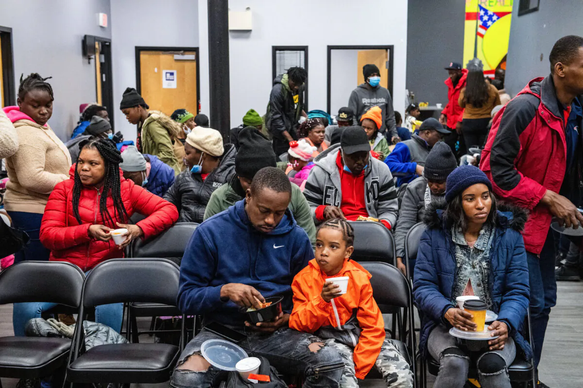 Illegal immigrants eat a meal at the La Colaborativa day shelter in Chelsea, Mass., on Feb. 22, 2024. (Joseph Prezioso/AFP via Getty Images)