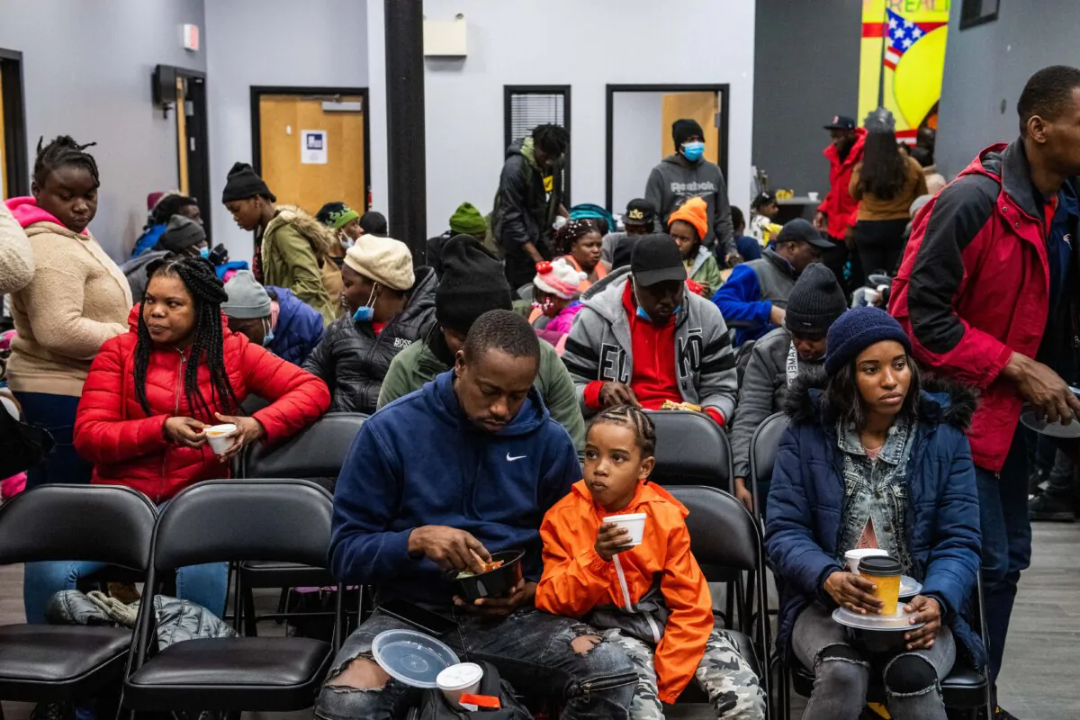 Migrants eat a meal at the La Colaborativa day shelter in Chelsea, Mass., on Feb. 22, 2024. (Joseph Prezioso/AFP via Getty Images)