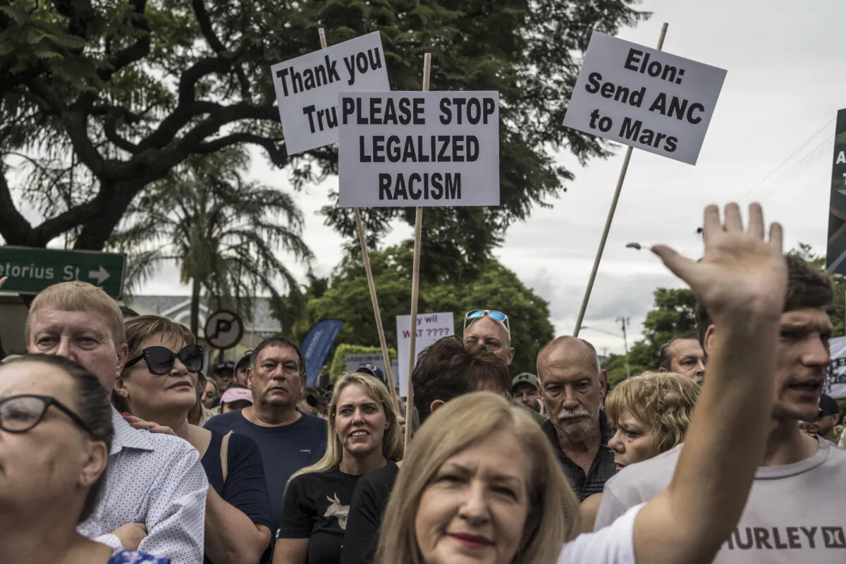 White South Africans supporting U.S. President Donald Trump and South African and U.S. tech billionaire Elon Musk gather in front of the U.S. Embassy in Pretoria, on Feb. 15, 2025.(Marco Longari/AFP via Getty Images)
