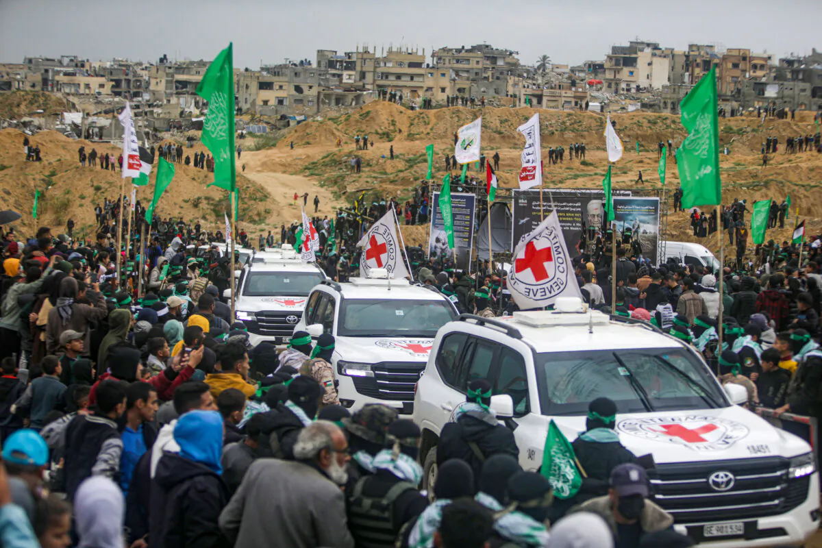 Red Cross vehicles arrive to collect the coffins containing the bodies of four Israeli hostages—including a mother and her two children, who had long been feared dead—to be handed over by Palestinian militant groups in Khan Younis, southern Gaza Strip, on Feb. 20, 2025. (Jehad Alshrafi/AP Photo)