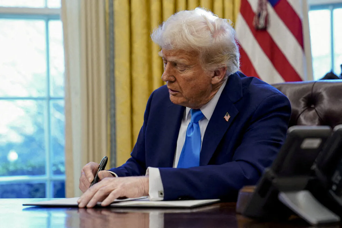 President Donald Trump signs a document in the Oval Office at the White House in Washington on Feb. 4, 2025. (Elizabeth Frantz/Reuters)
