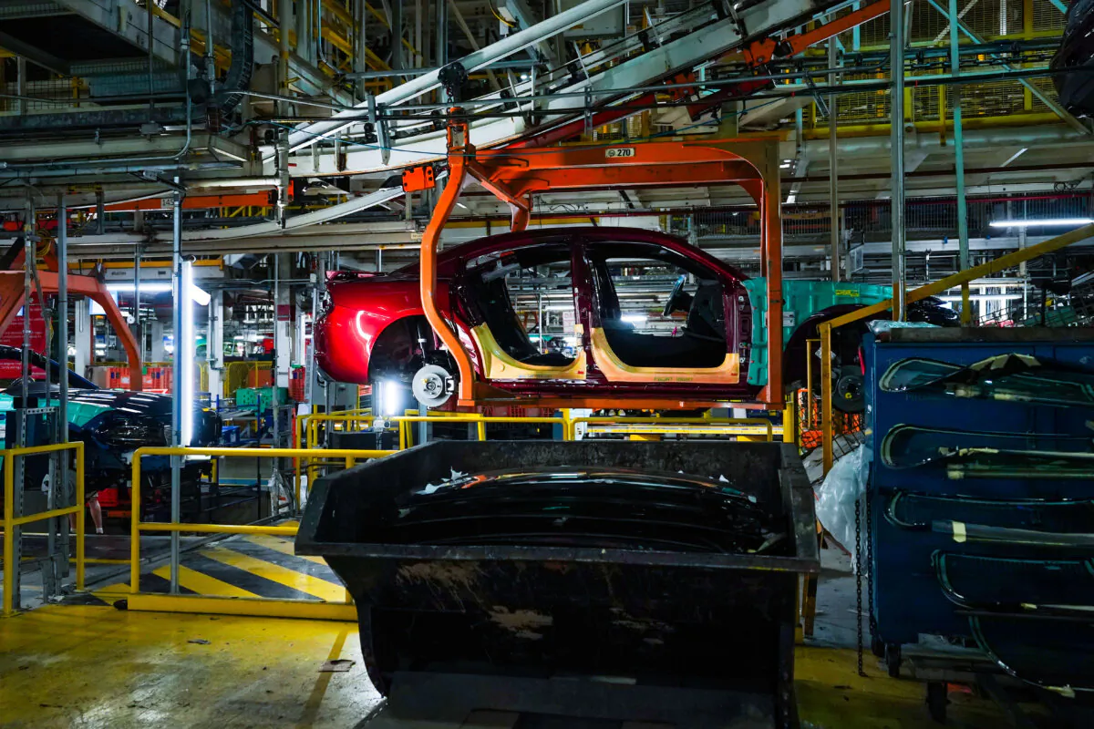 Cars pass along the assembly line at the Stellantis plant in Brampton, Ont., on July 21, 2023. (The Canadian Press/Chris Young)