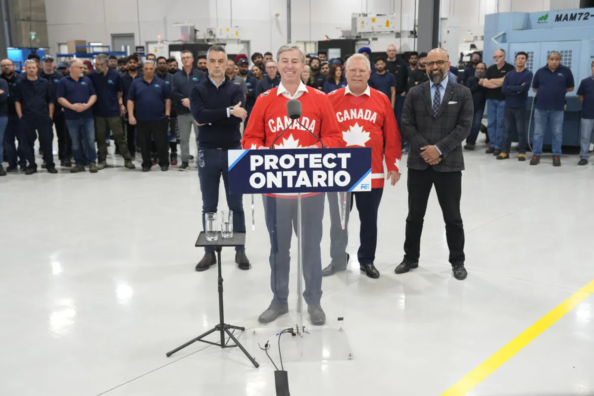 Nova Scotia Premier Tim Houston stands at the podium as he joins Ontario PC Leader Doug Ford on a campaign stop at HPG, a manufacturing facility in Milton, Ont., on Feb. 20, 2025. (Chris Young/The Canadian Press)