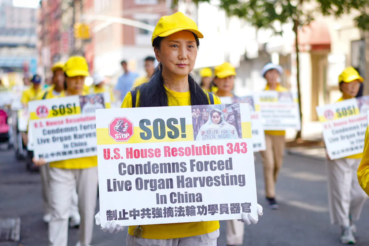 Falun Gong practitioners take part in a parade to commemorate the 24th anniversary of the persecution of the spiritual discipline in China, in New York City's Chinatown on July 15, 2023. (Samira Bouaou/The Epoch Times)