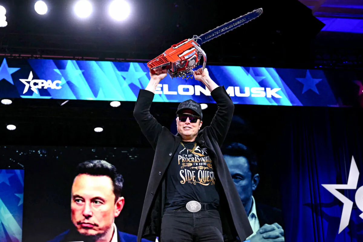 Elon Musk holds up a chainsaw during the annual Conservative Political Action Conference (CPAC) in Oxon Hill, Md., on Feb. 20, 2025. (Saul Loeb/AFP via Getty Images)