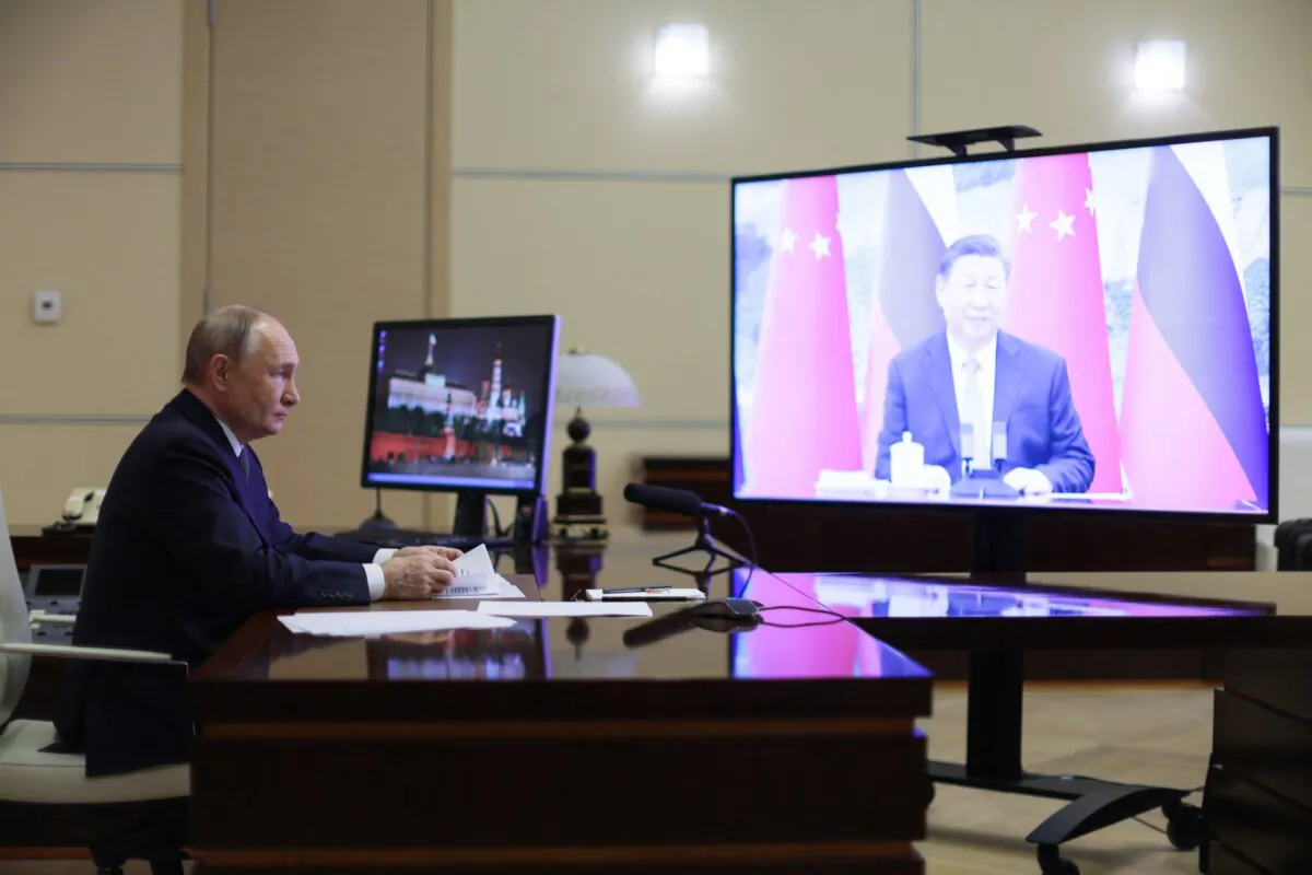 Russian President Vladimir Putin holds a video call with Chinese leader Xi Jinping at the Novo-Ogaryovo state residence outside Moscow on Jan. 21, 2025, in a pool photograph distributed by the Russian state agency Sputnik. (Gavriil Grigorov/POOL/AFP via Getty Images)