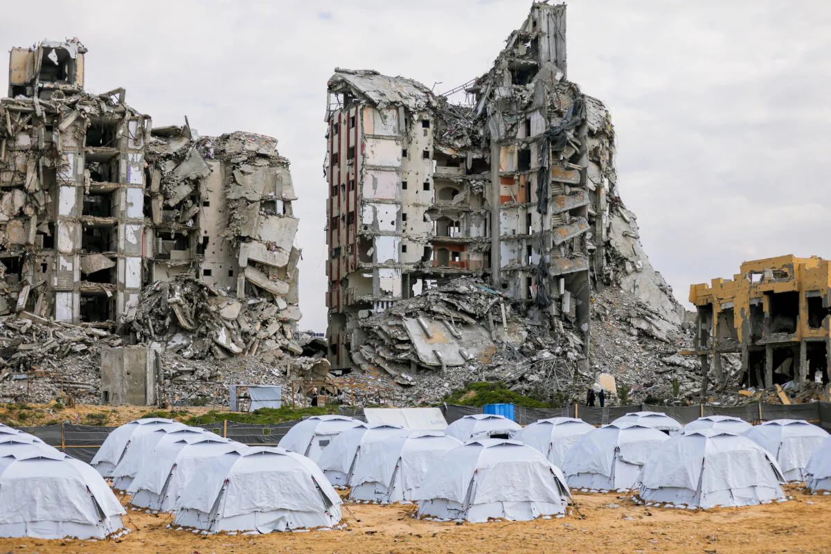 A view of tents in front of a ruined high-rise building in Gaza City, Jabalia refugee camp, in the northern Gaza Strip on February 24, 2025. In winter and cold, Palestinian citizens continue their daily lives in the ruins of their homes. (Photo by Youssef Alzanoun / Middle East Images / Middle East Images via AFP) (Photo by YOUSSEF ALZANOUN/Middle East Images/AFP via Getty Images)