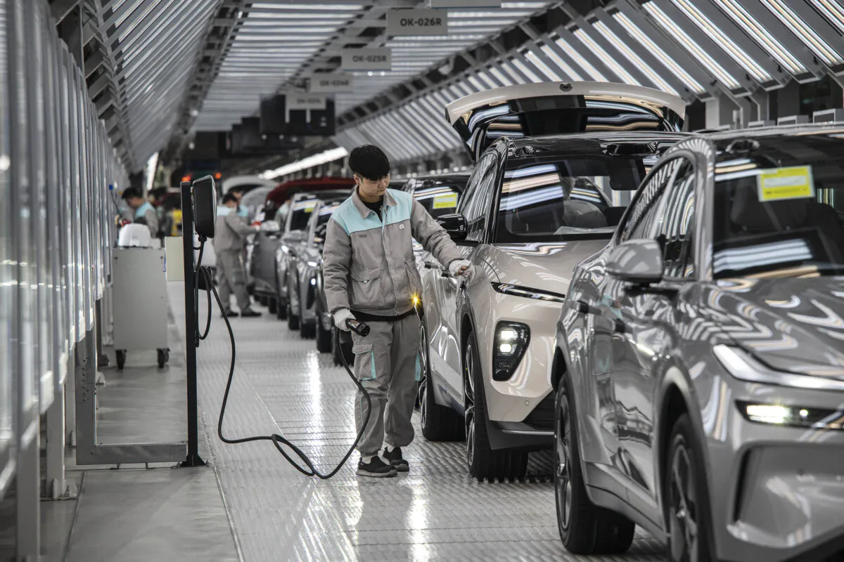 A worker inspects a vehicle charging system in Hefei, China, on Jan. 17, 2025. (Kevin Frayer/Getty Images)