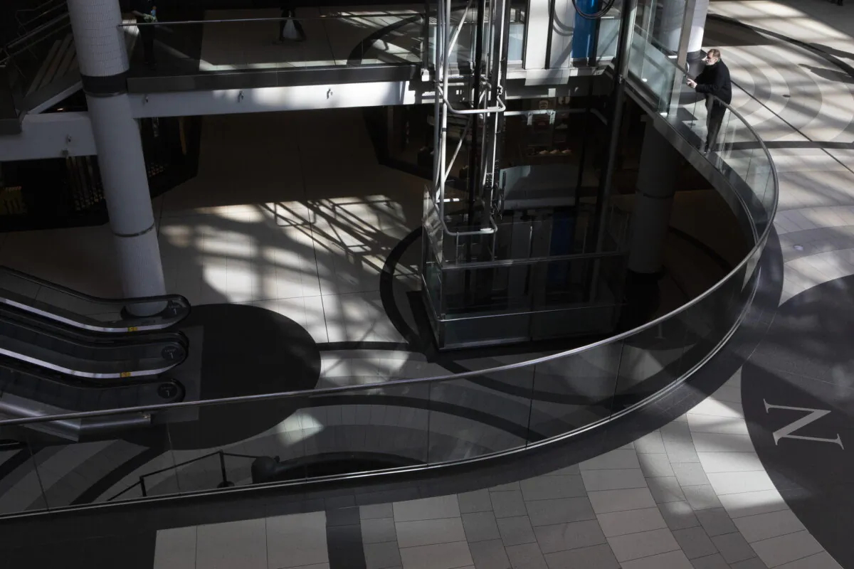 A man leans on a railing at Toronto's Eaton Centre shopping mall on March 21, 2020. (The Canadian Press/Chris Young)