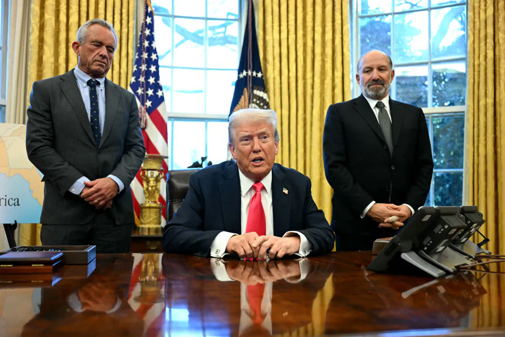 President Donald Trump, flanked by Secretary of Health and Human Services Robert F. Kennedy Jr. (L) and Secretary of Commerce Howard Lutnick, speaks to the press in the Oval Office on Feb. 25, 2025. (Jim Watson/AFP via Getty Images)