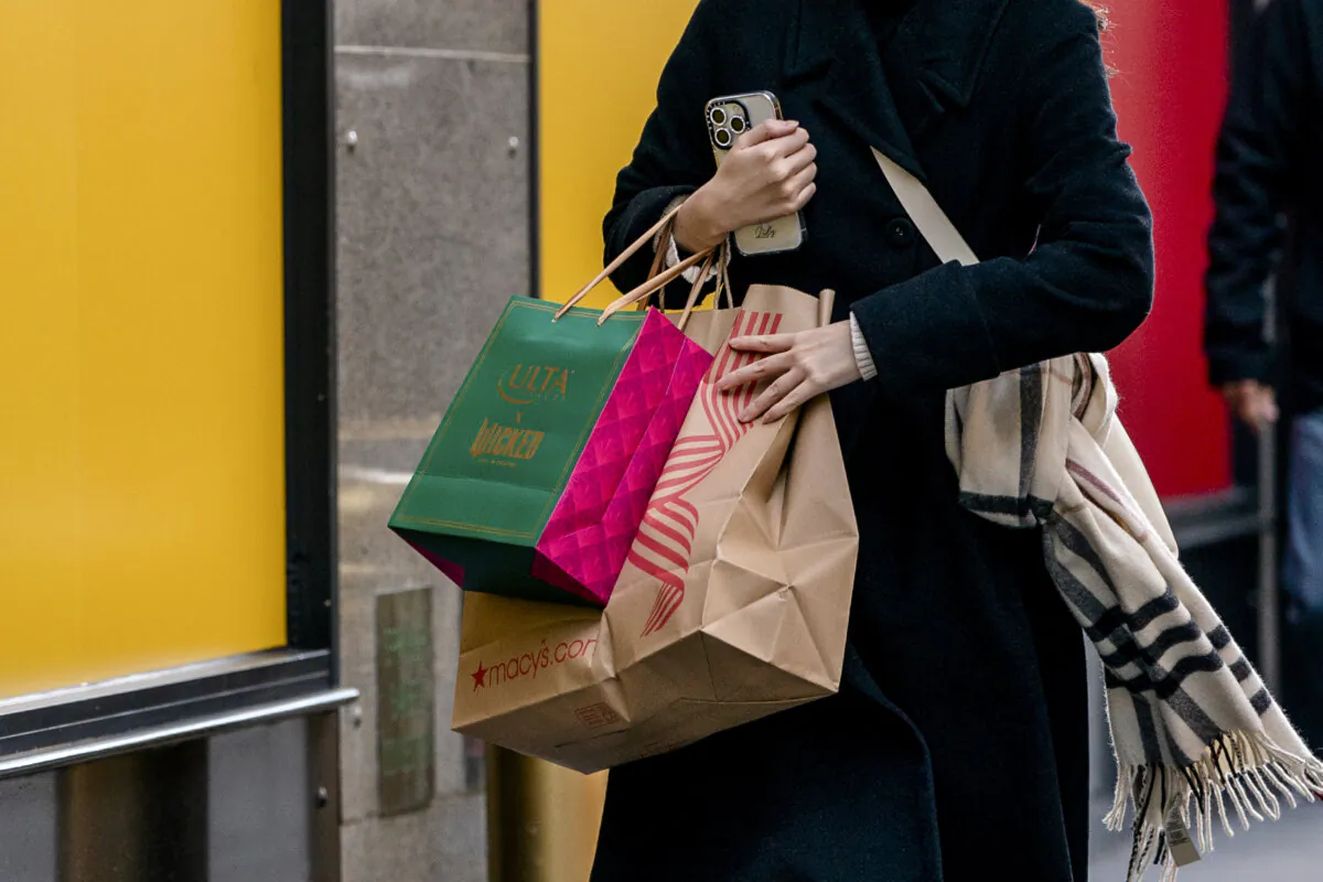 A person walks down a street with shopping bags in New York City, on Nov. 29, 2024. (David Dee Delgado/Getty Images)