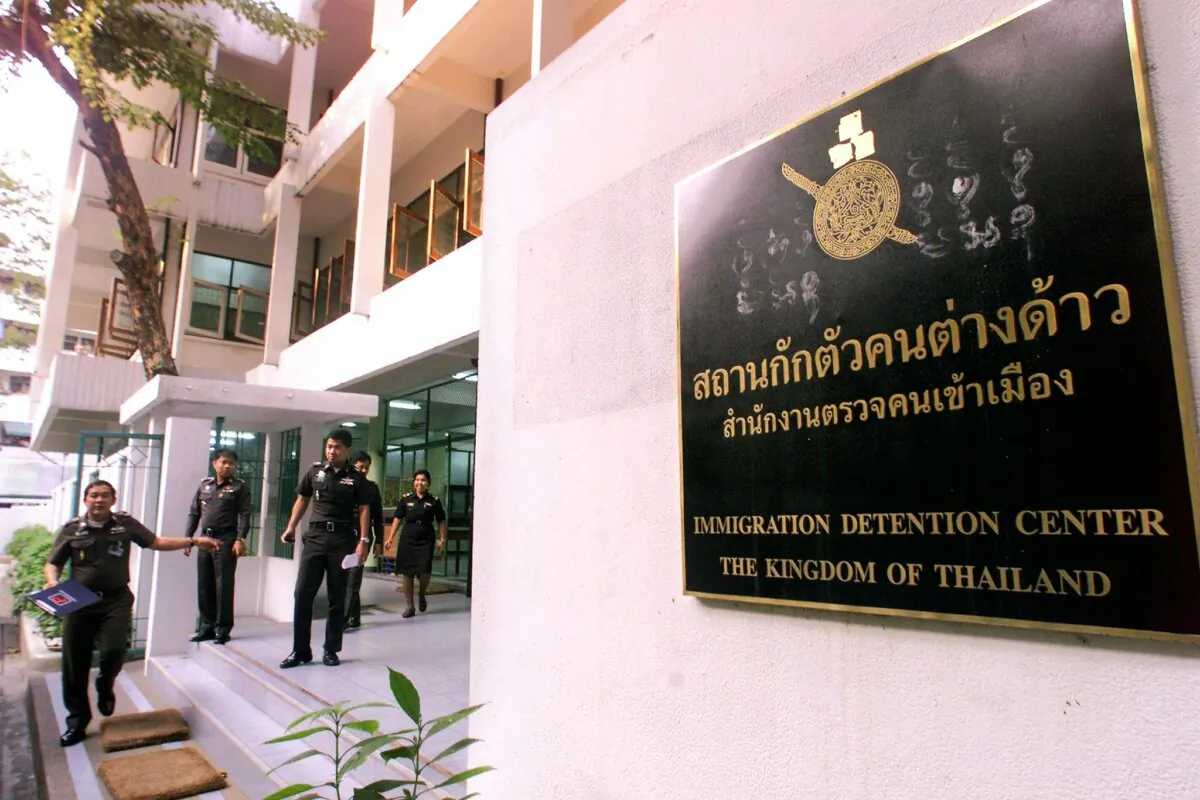 Thai immigration officers leave the Immigration Detention Center in Bangkok on Jan. 11, 2000, where Rahoual Miloud, an Algerian national is detained. Thai police said they arrested Miloud but had no evidence so far to support press reports that he was linked with terror suspect Osama bin Laden. (Pornchai Kittiwongsakul/AFP via Getty Images)