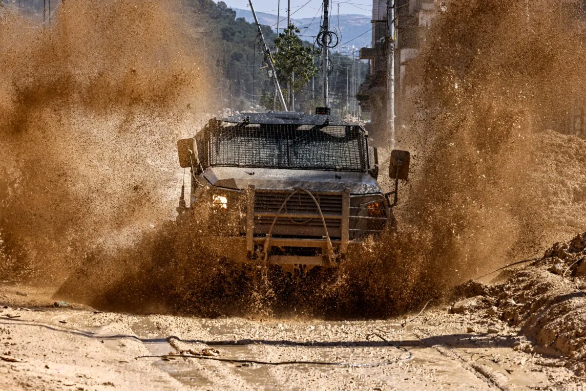 Israeli forces drive on a destroyed road in the Nur Shams camp for Palestinian refugees near Tulkarem, after reportedly issuing demolition notifications for several houses amid a weeks-long offensive in the West Bank, on Feb. 26, 2025. (Zain Jaafar /AFP via Getty Images)