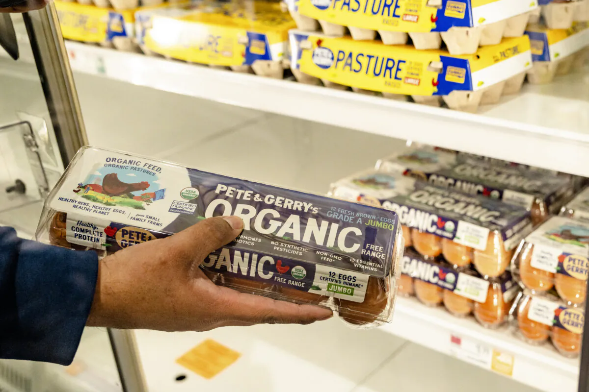 A person grabs a carton of eggs at a store in New York City on Feb. 17, 2025. (Samira Bouaou/The Epoch Times)