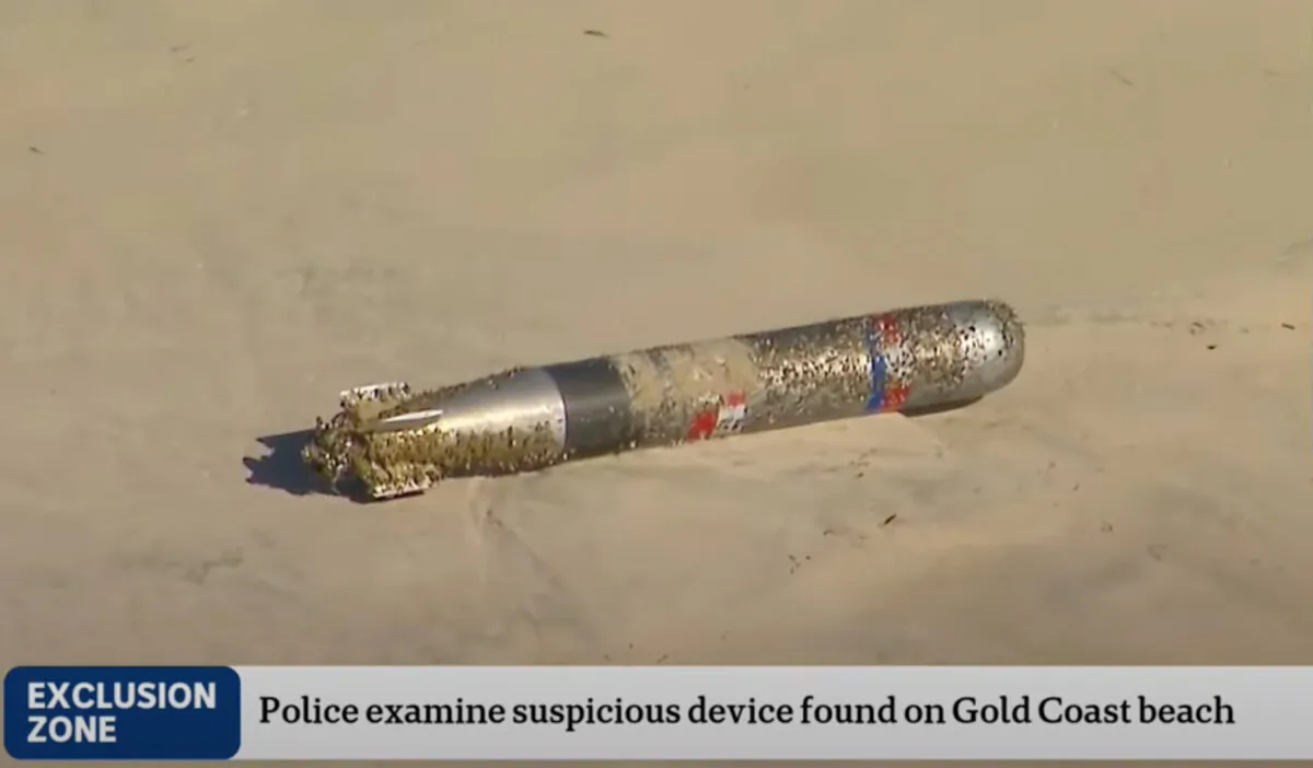 A still image taken from video and obtained on Feb. 27, 2025, shows a military device, possibly a torpedo, on the sand at Main Beach on the Gold Coast, Queensland. in Australia. (AAP Image/Supplied, ABC News) 