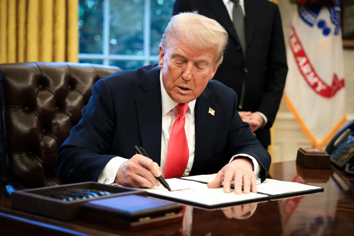 President Donald Trump signs an executive order in the Oval Office at the White House in Washington on Feb. 25, 2025. (Alex Wong/Getty Images)