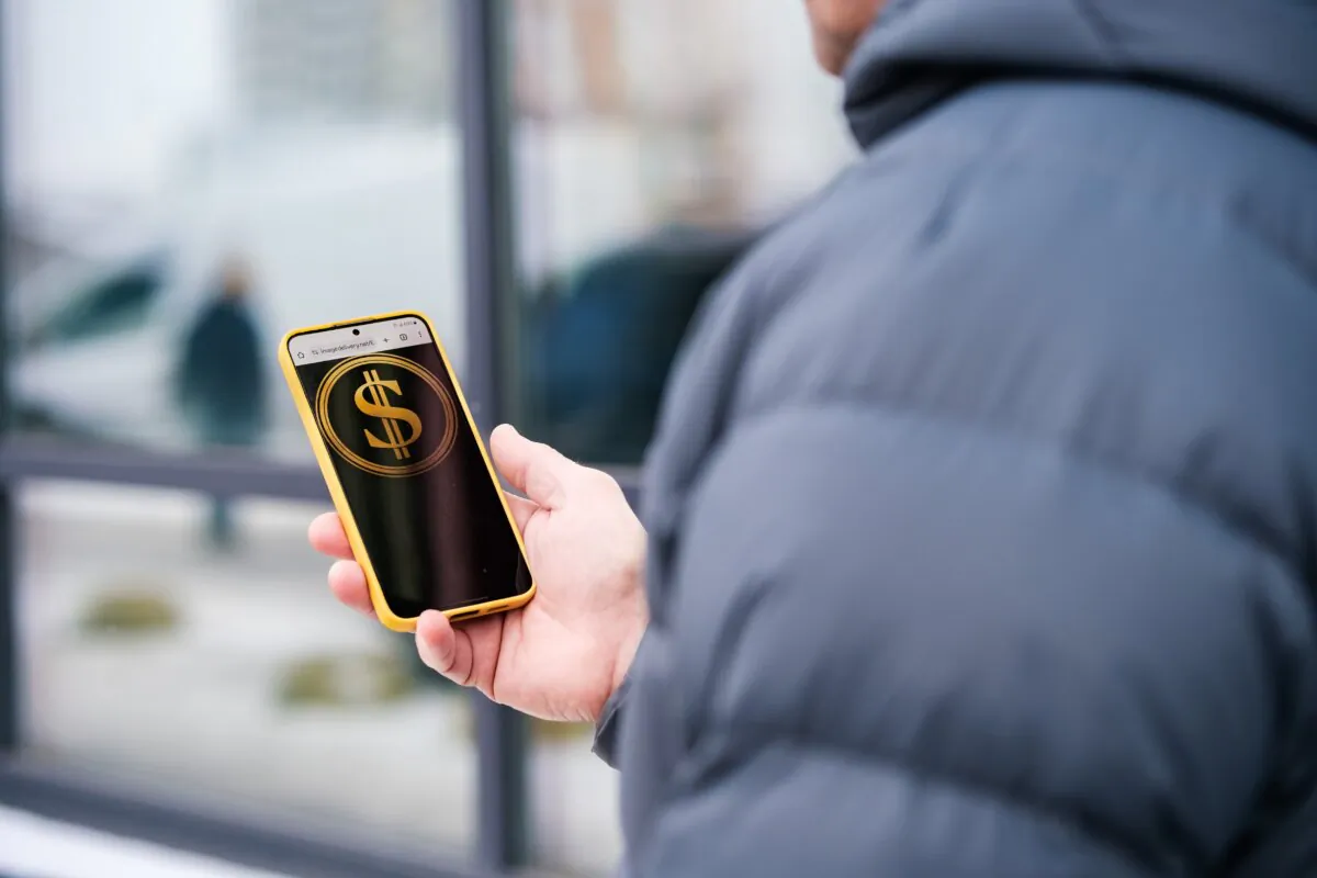 The Department of Government Efficiency website is displayed on a phone in a file photo. (Oleksii Pydsosonnii/The Epoch Times)
