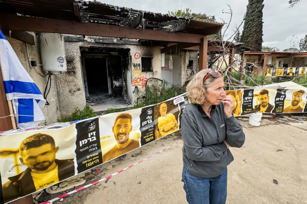 Rachel Stalmer, a Kfar Aza kibbutz resident, shows a visitor some of worst Oct. 7 damage at the kibbutz, in Israel on March 7, 2024. (Dan M. Berger/The Epoch Times)