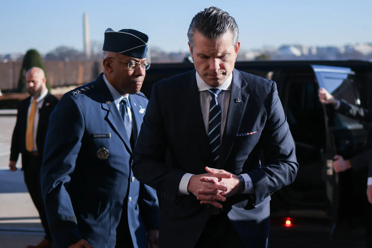 Secretary of Defense Pete Hegseth (R) arrives at the Pentagon for the first time since being confirmed after being greeted by Chairman of the Joint Chiefs of Staff Gen. C.Q. Brown (L) in Arlington, Va., on Jan. 27, 2025. (Win McNamee/Getty Images)