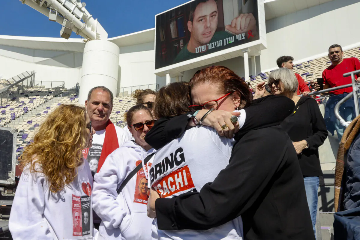 The mother of late Israeli hostage Tsachi Idan is hugged by a friend before the start of a Hapoel Tel Aviv club match as part of a public memorial ceremony in honour of Idan, who was a Hapoel supporter, at Bloomfield Stadium with in Tel Aviv on Feb. 28, 2025. Hamas on Feb. 27, handed over to Israel the bodies of four hostages, including Tsachi Idan, held in Gaza since its October 7, 2023 attack in exchange for more than 600 Palestinian prisoners. (Gil Cohen -Magen/AFP via Getty Images)