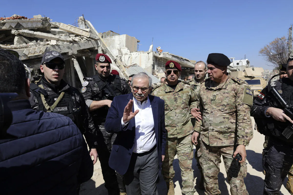 Lebanese Prime Minister Nawaf Salam walks among Lebanese army soldiers as he visits the southern village of Khiam near the border with Israel after the withdrawal of Israeli forces from the area under a cease-fire deal with Hezbollah, , on Feb. 28, 2025. (Rabih Daher/AFP via Getty Images)