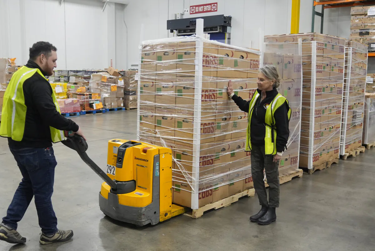 Rosemary Farm representatives Jose Pelayo (L) and Lisa Stothart (R) deliver eggs to those in need at the Los Angeles Food Regional Bank in City of Industry, Calif., on Feb. 12, 2025. (Damian Dovarganes/AP Photo)