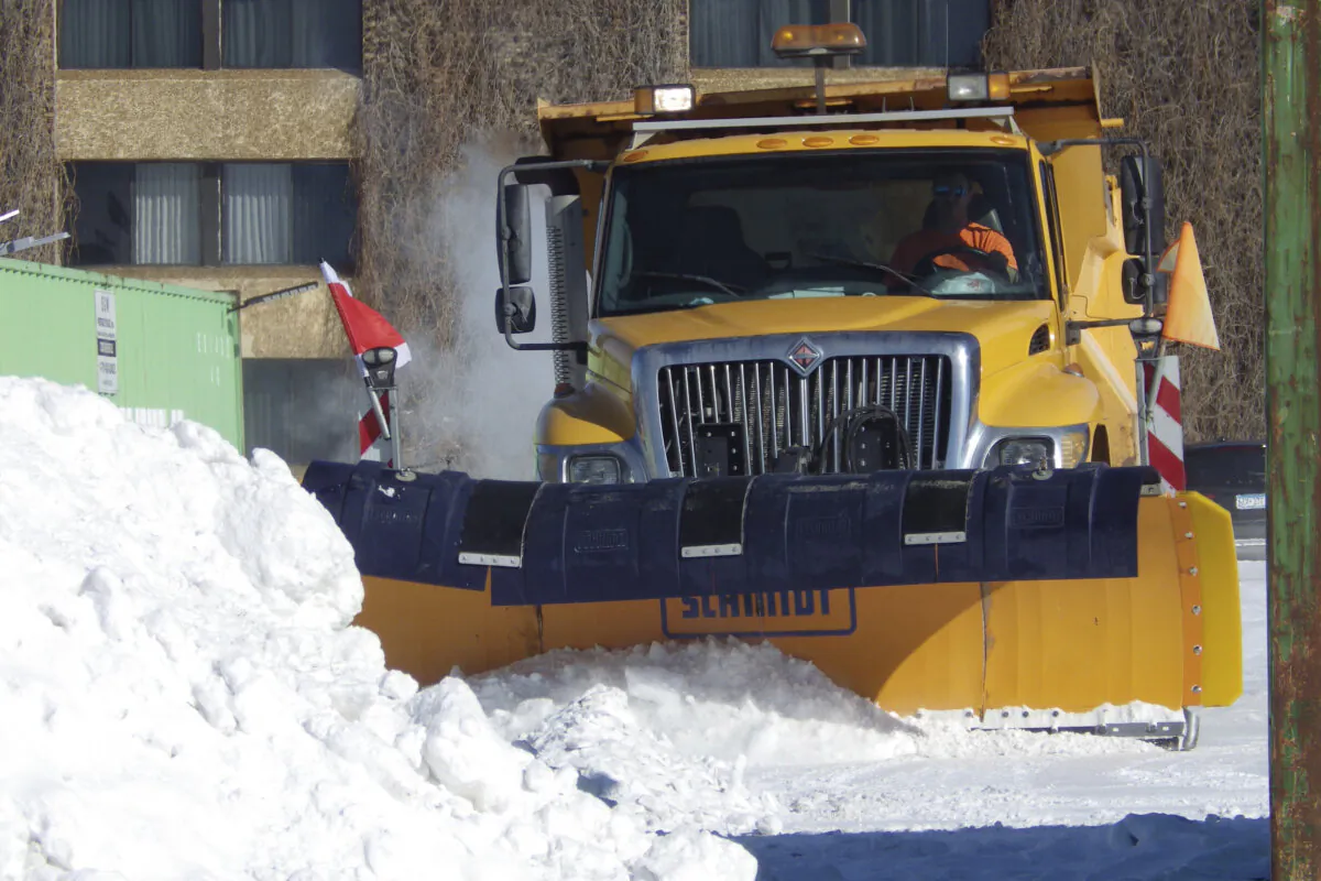 A snow plow clears a hotel's parking lot in Bismarck, N.D., on Feb. 18, 2025. (Jack Dura/AP Photo)