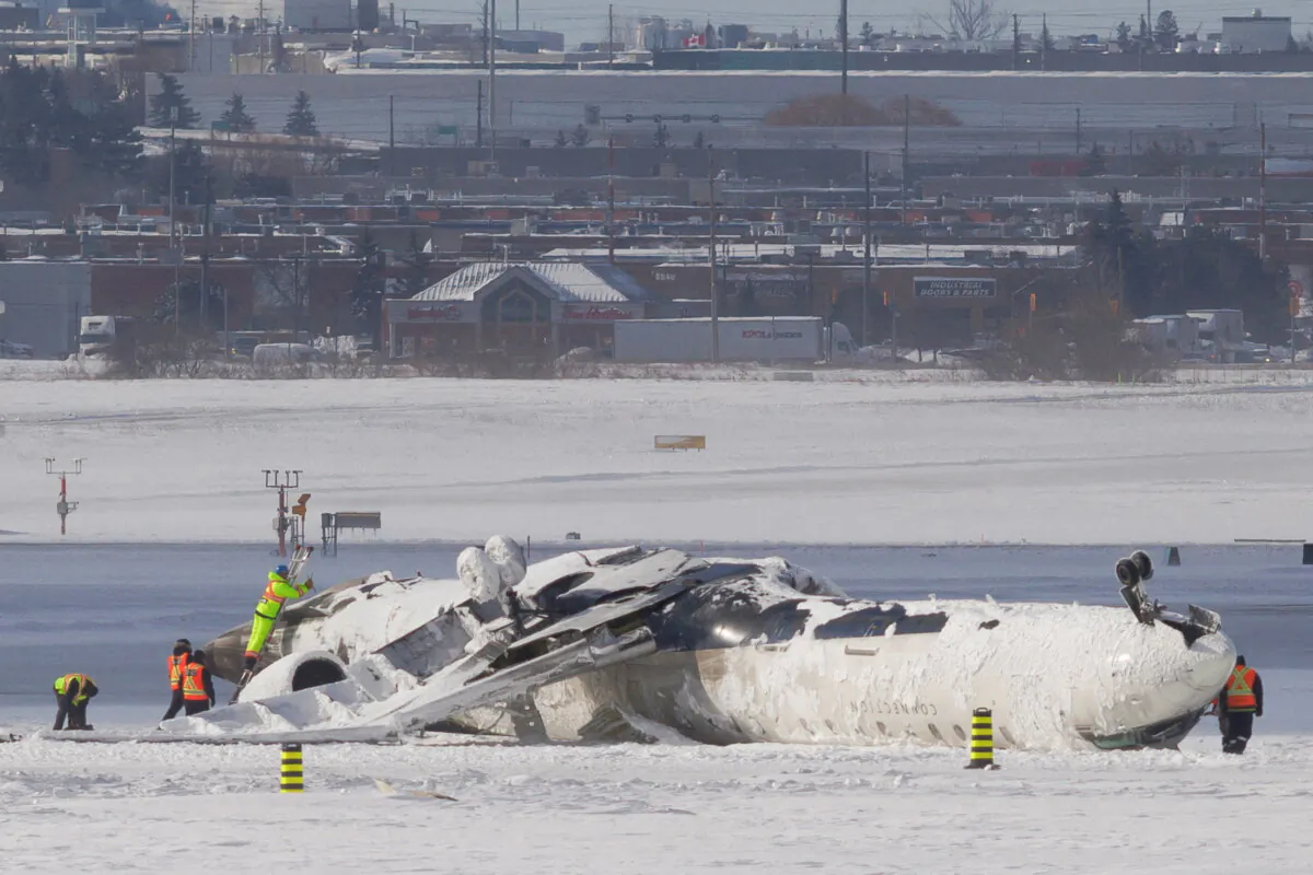 The wreckage of a Delta Air Lines operated CRJ900 aircraft lies on the runway following a crash at Toronto Pearson International Airport in Mississauga, Ontario, Canada, on Feb. 18, 2025. (Cole Burston/Reuters)