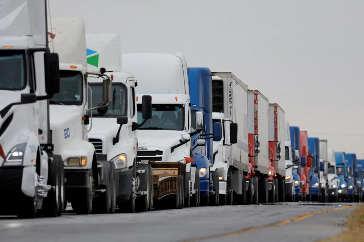 Trucks wait in line to cross into the United States near the border customs control at the World Trade Bridge in Nuevo Laredo, Mexico, on Nov. 26, 2024. (Reuters/Daniel Becerril)
