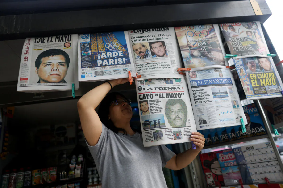 A newspaper seller arranges newspapers reporting the El Paso, Texas, arrest of Mexican drug lord Ismael "El Mayo" Zambada and Joaquin Guzman Lopez, "El Chapo" Guzman's son, in Mexico City on July 26, 2024. (Gustavo Graf/Reuters)