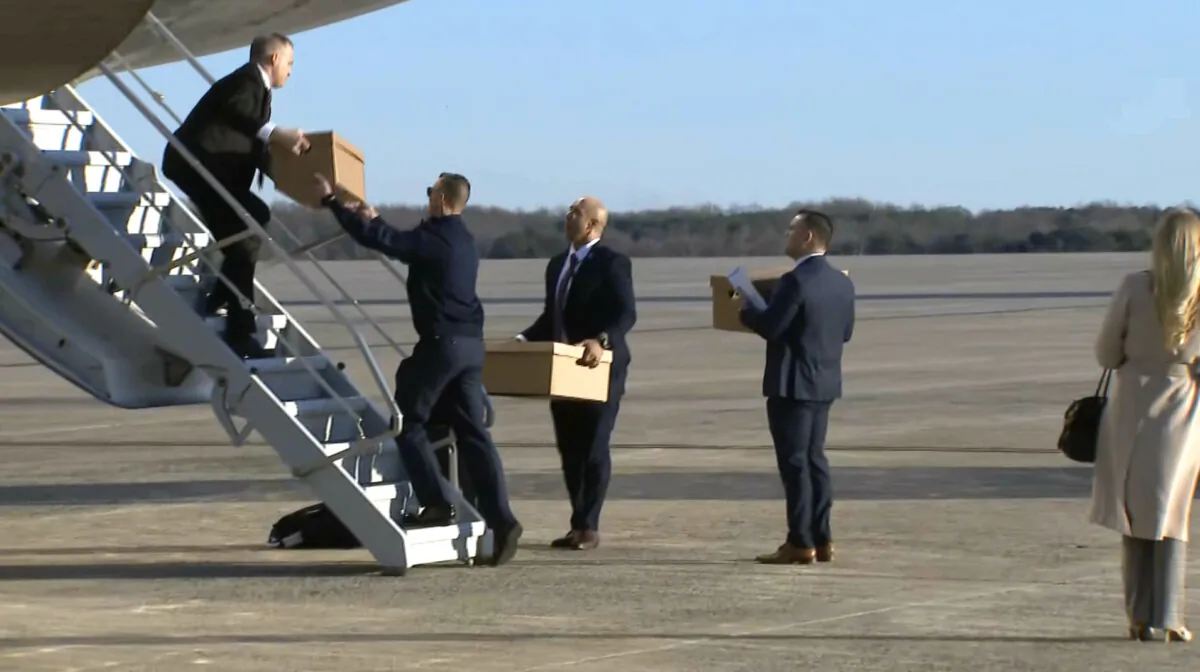Boxes are loaded onto Air Force One before President Donald Trump's departure at Joint Base Andrews, Md., on Feb. 28, 2025. (Pool/Screenshot via The Epoch Times)
