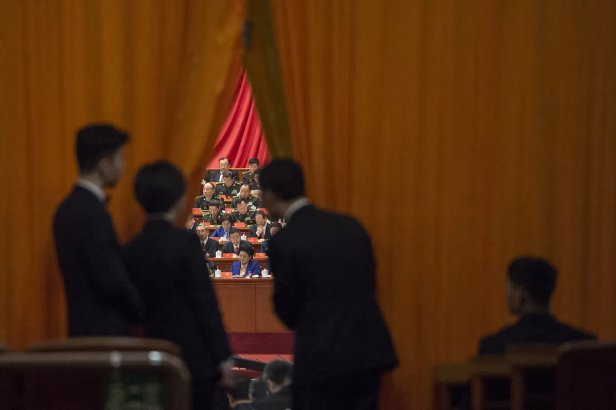 Chinese security guards look at military delegates during the speech of Chinese leader Xi Jinping at the Communist Party's 19th Congress in Beijing on Oct. 18, 2017. (Fred Dufour/AFP via Getty Images)